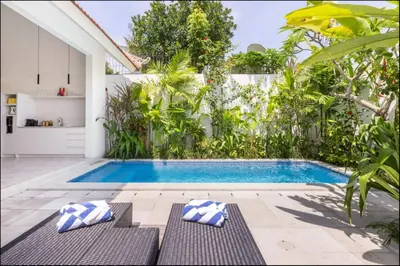 a swimming pool in the backyard of a house at Villa Harris Canggu in Canggu