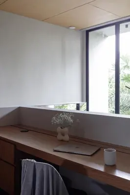 a desk in a room with a large window at OXO Townhouses Berawa Canggu in Canggu