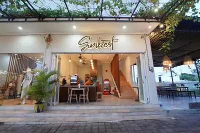 a sunburst store front with tables and chairs in it at Sunkiest House Canggu in Canggu