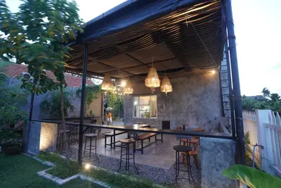 an outdoor dining area with a table and chairs at Sunkiest House Canggu in Canggu
