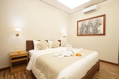 a bedroom with a bed with a stuffed animal on it at Sunkiest House Canggu in Canggu