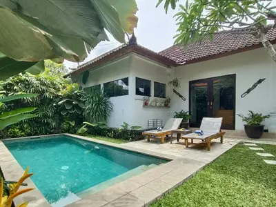 a villa with a swimming pool in front of a house at Villa MONTI - LEGIAN - SEMINYAK - Lovely 2 Bedroom Villa - Great Location ! in Seminyak