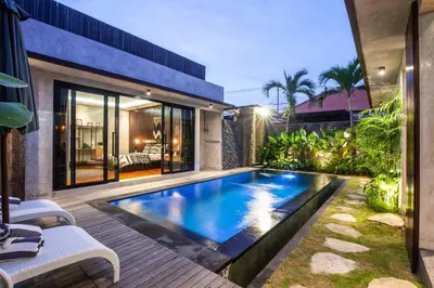a swimming pool in the backyard of a house at Simple And Magical . VILLA ALMAYA in Seminyak