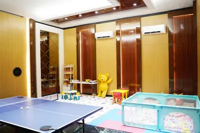 a room with a ping pong table and a toy at Boss Legian Hotel Powered by Archipelago in Legian