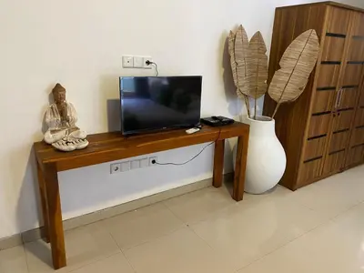 a flat screen tv sitting on top of a wooden table at Villa Tenang Legian in Legian