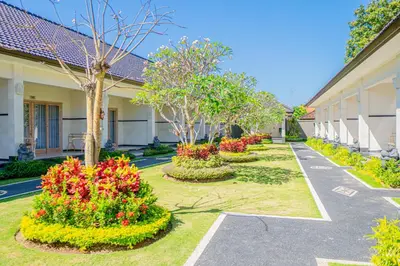 a row of flowers in front of a building at Green D'mel Bali in Nusa Dua