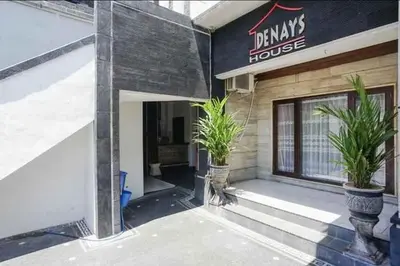 a building with potted plants in front of a building at DENAYS GUESTHOUSE JIMBARAN in Jimbaran