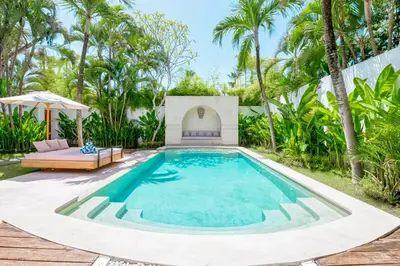 a swimming pool in a backyard with a gazebo and palm trees at Villa Chandika - 4 BDR Villa with private Pool, walk to the beach in Seminyak