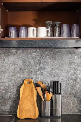 a counter with a bunch of utensils on a shelf at Casa Jinah 1 I Simply Modern Twin Villas (2BR) with Private Pool in Seminyak