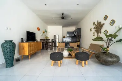 a living room with a table and chairs at Casa Jinah 1 I Simply Modern Twin Villas (2BR) with Private Pool in Seminyak