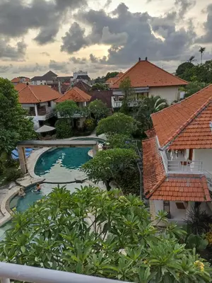 a view of a pool from the balcony of a resort at Kusnadi Hotel in Legian