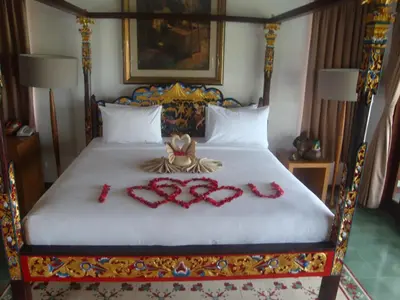 a bedroom with a bed with red decorations on it at Aqua Octaviana Bali Villa in Canggu