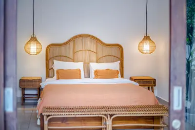 a bedroom with a large bed with two lamps at Villa Deba 2 by Bali Villa Solutions in Seminyak