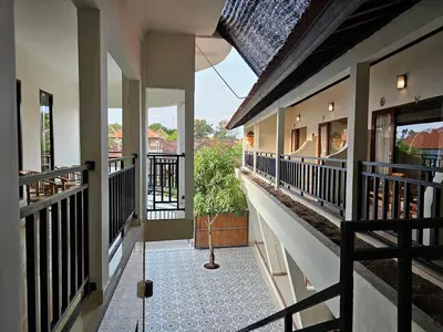 a hallway of a house with a balcony at Tegalsari Guest House Canggu in Canggu