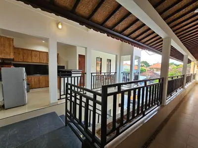 an open kitchen and living room of a house at Tegalsari Guest House Canggu in Canggu