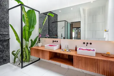 a bathroom with two sinks and a large mirror at Villa Giraffe Seminyak, 4br short walk to Potato Head in Seminyak