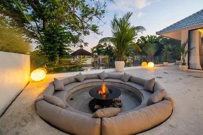 a patio with a couch and a fire pit at Villa Giraffe Seminyak, 4br short walk to Potato Head in Seminyak