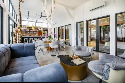 a living room with blue couches and a table at Villa Giraffe Seminyak, 4br short walk to Potato Head in Seminyak