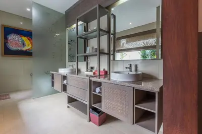 a bathroom with two sinks and a large mirror at Villa Lisha in Canggu
