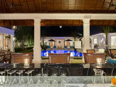 a bar in a restaurant with wine glasses at Villa Windu Asri in Seminyak