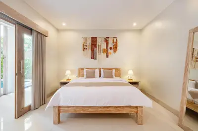 a bedroom with a large bed and two lamps at ☆ Villa Larissa ☆ Seminyak 2BR Pool Kuta Petitenget in Seminyak