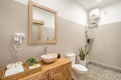a bathroom with a sink and a toilet and a mirror at ☆ Villa Larissa ☆ Seminyak 2BR Pool Kuta Petitenget in Seminyak