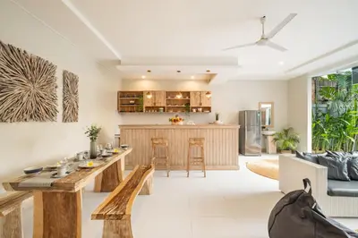 an open kitchen and living room with a wooden table at ☆ Villa Larissa ☆ Seminyak 2BR Pool Kuta Petitenget in Seminyak