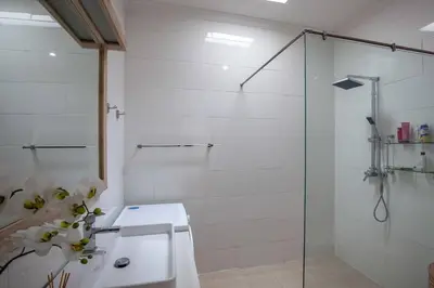 a bathroom with a glass shower stall and a toilet at Central Seminyak, 3BR, Ensuites, Sleep 6, Peaceful in Seminyak