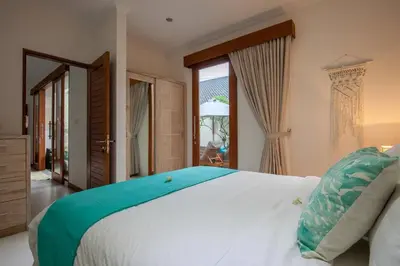 a bedroom with a large white bed and a window at Central Seminyak, 3BR, Ensuites, Sleep 6, Peaceful in Seminyak