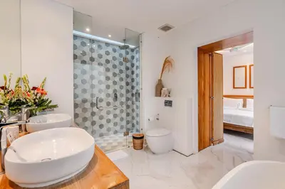 a bathroom with two sinks and a shower at Villa Vana, Sitara Villa Group in Seminyak