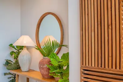 a mirror on a table with a lamp and a plant at Villa Mango 2 - Amazing 4-bdr Villa in Berawa ! PERFECT LOCATION in Canggu