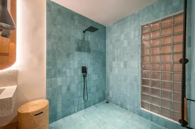 a bathroom with a shower with blue tiles at Villa Mango 2 - Amazing 4-bdr Villa in Berawa ! PERFECT LOCATION in Canggu