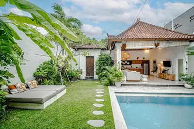 a backyard with a swimming pool and a house at Villa Deba 3 by Bali Villa Solutions in Seminyak