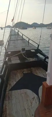 a wooden dock on a boat in the water at Celebbest in Kuta