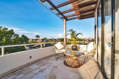 a balcony with a table and chairs and a view at Villa Kalita Bali in Seminyak