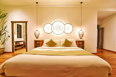 a bedroom with a large bed with two rings on the wall at Villa Kalita Bali in Seminyak