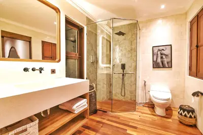 a bathroom with a shower and a sink and a toilet at Villa Kalita Bali in Seminyak