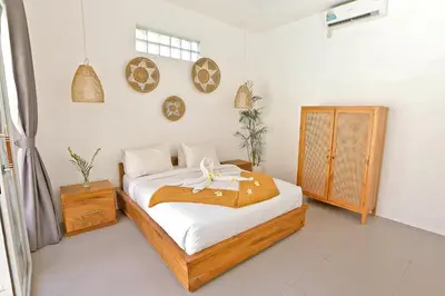 a bedroom with a bed with a flower on it at Villa Elijah in Seminyak