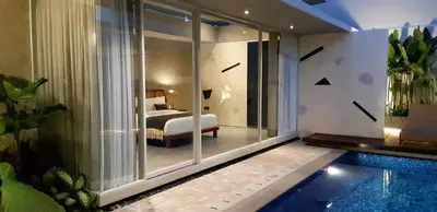 a hotel room with a swimming pool and a bedroom at Villa Mandja - Stunning architect-designed 3BR villa in Petitenget in Seminyak