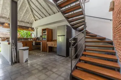 a kitchen with a spiral staircase in a house at Villa Madura DREAM 3bdrs Central Seminyak in Seminyak