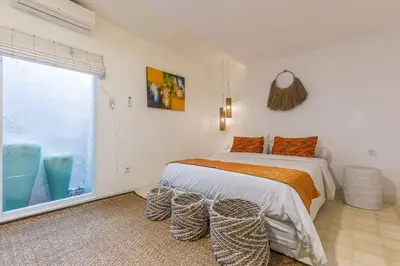 a bedroom with a bed and a large window at Villa Madura DREAM 3bdrs Central Seminyak in Seminyak
