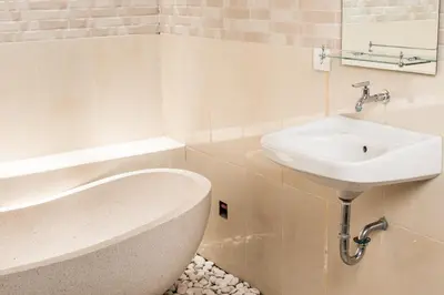 a bathroom with a sink and a bath tub at Relax Bali Villas in Legian