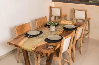 a wooden table with four chairs and hats on it at Relax Bali Villas in Legian