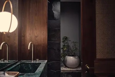 a bathroom with two sinks and a potted plant at Munno Villa in Canggu