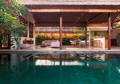 a house with a swimming pool in front of a house at Villa Andalas in Seminyak