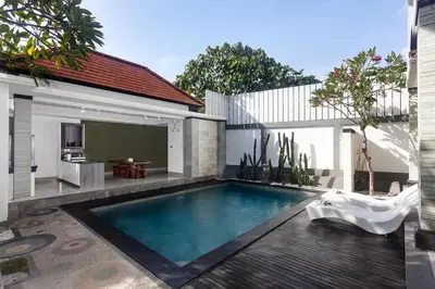 a swimming pool in the backyard of a house at Maja Villa Batubelig by GenuineHost in Canggu