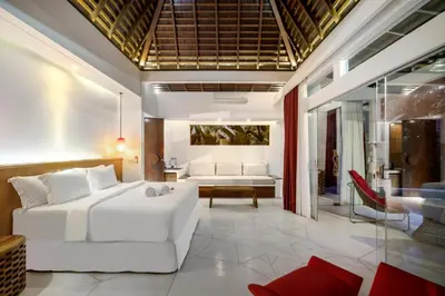 a living room with a white couch and a table at Umani Village in Kerobokan