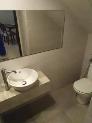 a bathroom with a sink and a toilet at LBV Seminyak Apartment in Seminyak