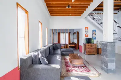 a living room with a couch and a table at Villa Padma by Best Deals Asia Hospitality in Nusa Dua