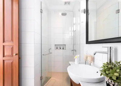 a white bathroom with a sink and a shower at Villa Anahera Seminyak in Seminyak